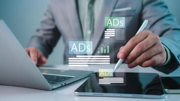 Digital marketing concept, Businessman using laptop and tablet with Ads dashboard digital marketing strategy analysis for branding, online advertisement, Ad on website and social media, SEO. photo