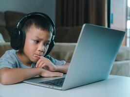 Online education, Technology studying at home using laptop computer, Student distance learning virtual distance online class on call virtual lesson, Teaching child boy with remote education. photo
