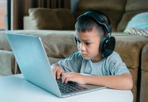 Online education, Technology studying at home using laptop computer, Student distance learning virtual distance online class on call virtual lesson, Teaching child boy with remote education. photo