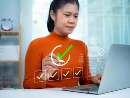 Businesswoman using a laptop. Online survey with digital forms and checklists, Technology and strategy for success in the business modern world, Transparency in organizations and companies. photo