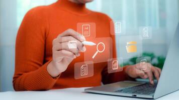 Businesswoman using laptop, Document management system concept, Folders and document icon software, Online document database file management Powerful company information Search and archive. photo