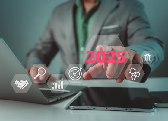 Businessman showing text 2025 in a hexagonal frame, Set goals for 2025, Implementation of business goals plan, Development to achieve goals and success, Changes in new planning, Business growth.