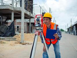 Surveyor and survey equipment on construction site, Land and soil development, Survey equipment, Theodolite for measurement construction work, Civil engineer or Architect working surveyor. photo