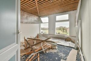A room with a broken window and a pile of debris photo