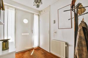 A hallway with a coat rack and a coat hanging on it photo