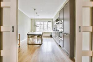 A view of a kitchen and dining room from an open door photo