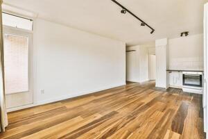 An empty room with wooden floors and white walls photo