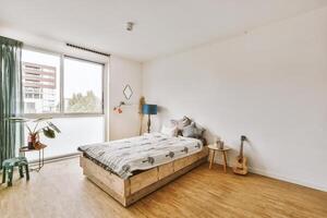 A bedroom with a bed and a window photo