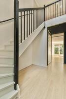 A white staircase in a home with wooden floors photo