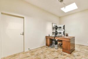 A room with a desk and a chair in it photo