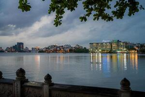 Hanoi, Vietnam - 25 Jun 2024 West Lake in Hanoi in the dark cloudy evening. Ha Noi cityscape. Travel concept photo