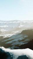 row of sharp dark cliffs standing out from the snow video