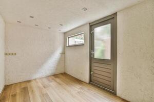 A room with a wooden floor and a door photo
