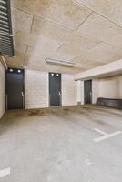 An empty parking garage with two doors photo