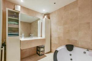 A bathroom with a large tub and a sink photo