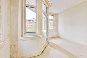 An empty room with a window and a door photo