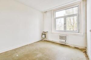 An empty room with a window and a floor photo