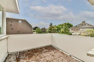 A balcony with a view of the city and trees photo