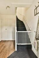 A hallway with a black carpet and a black stairway photo