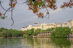 Hanoi, Vietnam - 26 June 2024 Hoan Kiem lake or Sword lake, Ho Guom in Hanoi, Vietnam with Turtle Tower, on clear day with blue sky and white clouds photo