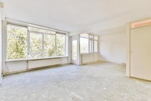 An empty room with a large window and a door photo
