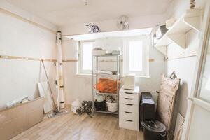 A room with a lot of clutter and a lot of things on the floor photo