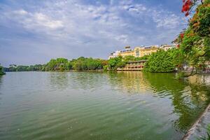 Hanoi, Vietnam - 26 June 2024 Hoan Kiem lake or Sword lake, Ho Guom in Hanoi, Vietnam with Turtle Tower, on clear day with blue sky and white clouds photo