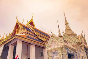 A golden Thai temple roof in Bangkok, showcasing intricate architecture and traditional, Wat Phra Kaew, Thailand. photo