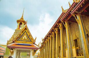A golden Thai temple roof in Bangkok, showcasing intricate architecture and traditional, Wat Phra Kaew, Thailand. photo