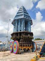 A temple chariot, also called a ratha or ther, is a large, intricately decorated wooden vehicle used in Hindu temple festivals. It plays a key role in the Brahmotsavam festival at Venkateswara Temple photo