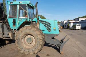 Stuttgart, Germany, 9 September 2023. A large tractor is standing in the parking lot at the end of the workday. Agricultural machinery in Germany. photo