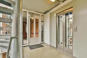An elevator in a building with a spiral staircase photo