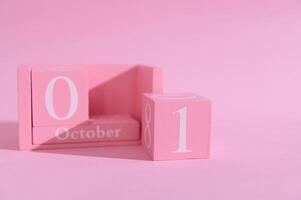 Pink wooden calendar blocks displaying October 01 against a light pink background, symbolizing a fresh start and a new beginning photo