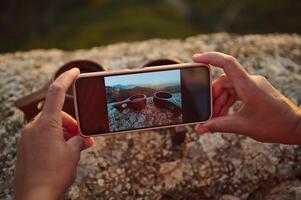 Capturing the scenic view of mountains through a smartphone for a unique perspective on outdoor adventures photo