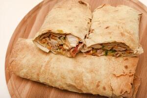 Meat shawarma on a cutting board. Burritos with meat. photo