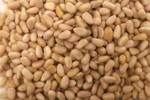 Pine nuts in close-up. Hazelnuts. photo
