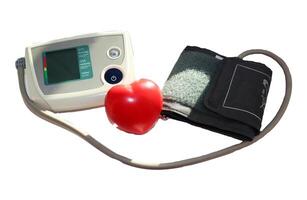 Electronic tonometer with the display turned off, with a cuff and a hand-held heart-shaped trainer - a medical device for measuring blood pressure, a color photo on a white background, isolated
