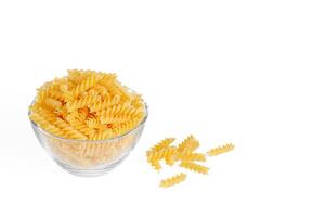 Pasta products in the form of a spiral on a plate, texture, on a white background photo