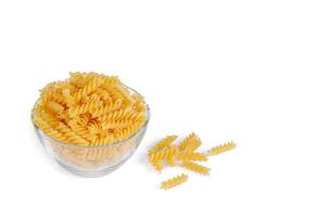 Pasta products in the form of a spiral on a plate, texture, on a white background photo
