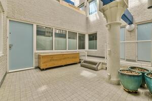 A courtyard with a bench and a door photo