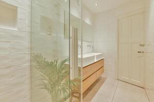 A bathroom with a sink and a shower stall photo