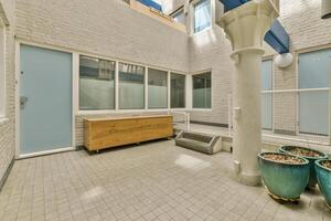 A courtyard with a bench and a door photo