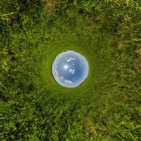 blue hole sphere or globe little planet inside sand or dry ground frame background with tractor tracks photo