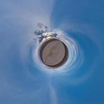 simple little tiny planet without buildings in blue sky with beautiful clouds. Transformation of spherical panorama 360 degrees. Spherical abstract aerial view. Curvature of space. photo