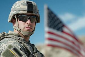 Close-up Portrait of a US Soldier Wearing Camouflage and a Helmet with an American Flag Blurred in the Background photo