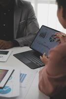 Close up of Business team analyzing income charts and graphs with modern laptop computer. Business analysis and strategy concept. photo