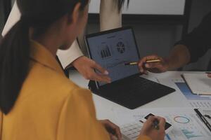 Close up of Business team analyzing income charts and graphs with modern laptop computer. Business analysis and strategy concept. photo