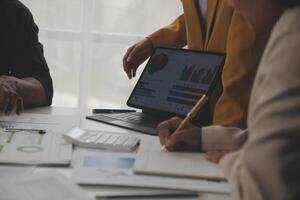 Close up of Business team analyzing income charts and graphs with modern laptop computer. Business analysis and strategy concept. photo