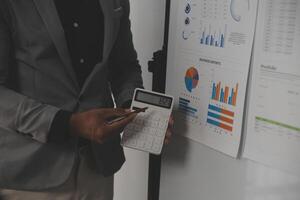 Close up of Business team analyzing income charts and graphs with modern laptop computer. Business analysis and strategy concept. photo