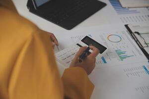 Close up of Business team analyzing income charts and graphs with modern laptop computer. Business analysis and strategy concept. photo